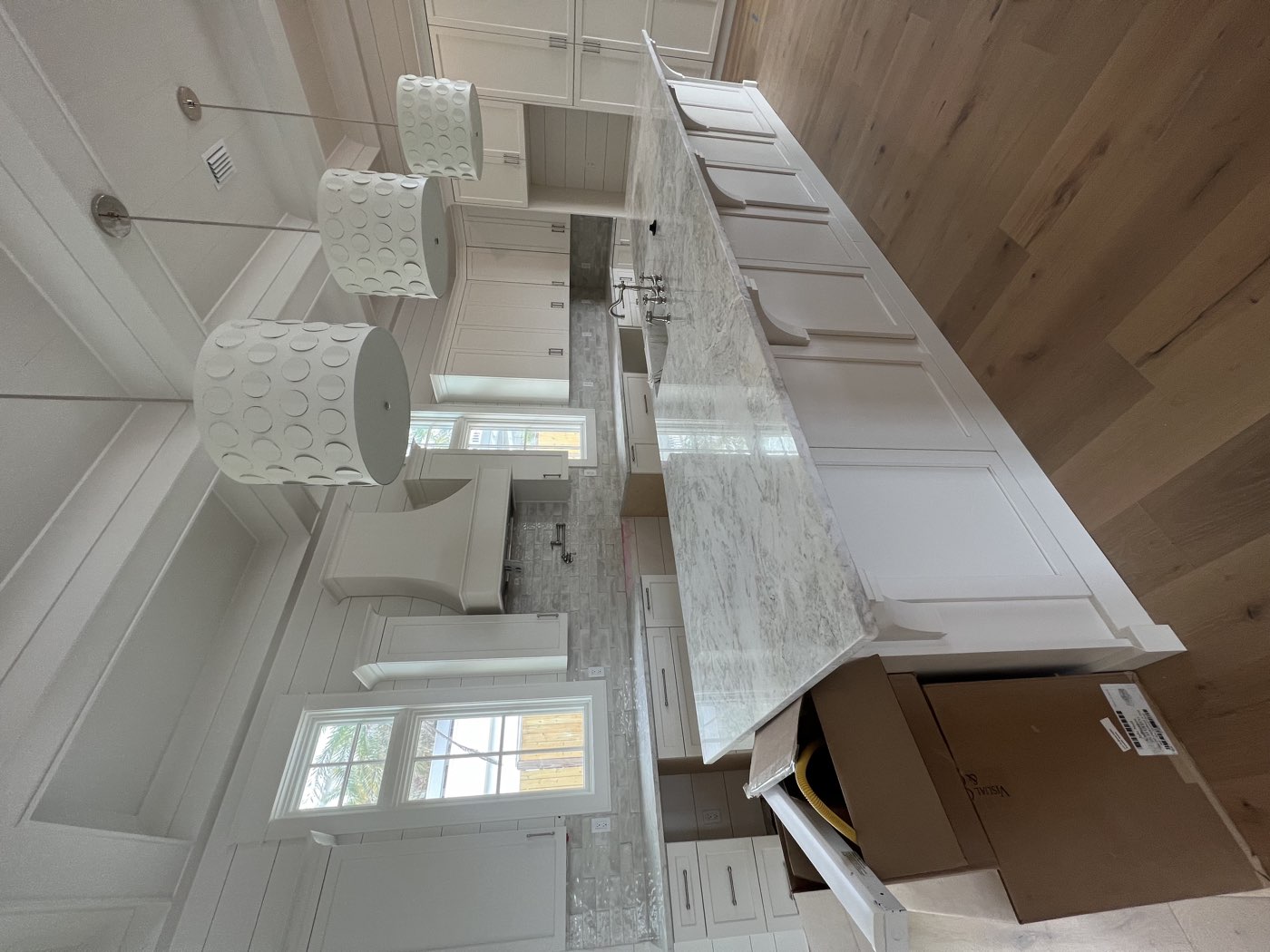 White kitchen with a large granite island