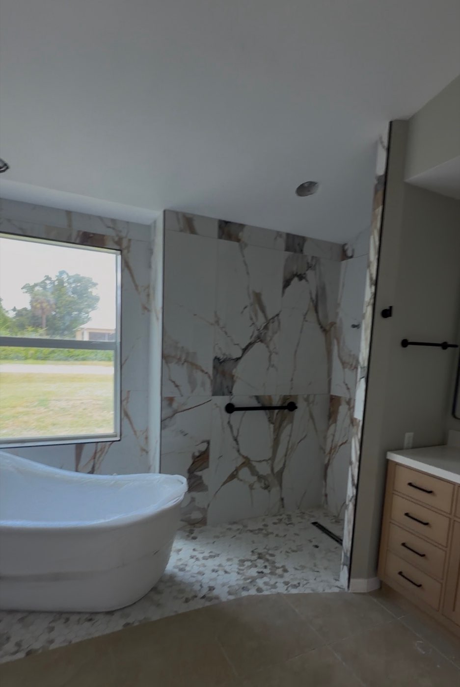 Ceramic tile shower wall with marble veining